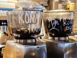 Kona Coffee Beans in Coffee Grinders. photo