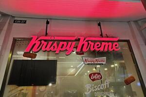 BANGKOK, THAILAND SEPTEMBER 25, 2023 Krispy Kreme Doughnuts Sign. Krispy Kreme is an American multinational doughnut company that was founded July 13, 1937. photo