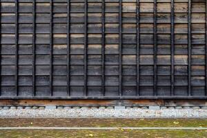 Old Wooden Wall in Japanese Style Background with Pavement in the Park. photo