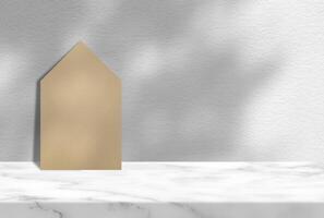 antiguo papel casa en mármol mesa con blanco hormigón pared antecedentes con árbol sombra, adecuado para producto presentación fondo, mostrar, y burlarse de arriba. foto