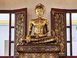 Ancient Golden Buddha Image at Wat Rakhang Kositaram Woramahawihan Temple, Bangkok Thailand. photo