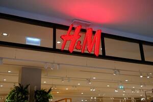 BANGKOK, THAILAND JULY 04, 2023 H and M Sign. H and M is a famous clothing in the world. It's found in 1947 by Mauritz Widforss. photo