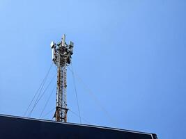 Telecom Pole on Roofs with Blue Sky. photo