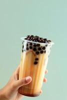 Female Hand Hold Fresh Made Boba Pearl Drink photo