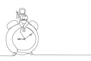 Continuous one line drawing young energetic astronaut sitting on giant alarm clock holding laptop raise one hand. Deadline work in spaceship launch planning. Single line design vector illustration