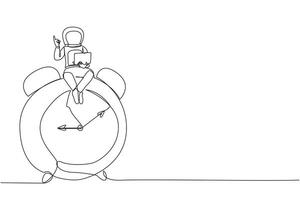 Continuous one line drawing young energetic astronaut sitting on giant alarm clock holding laptop raise one hand. Deadline work in spaceship launch planning. Single line design vector illustration