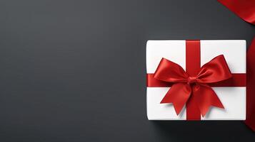 AI generated White gift box with a red ribbon and bow on a dark grey background. photo