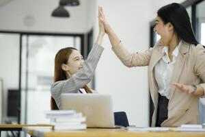 Successful Businesswomen Celebrating with a High Five. photo