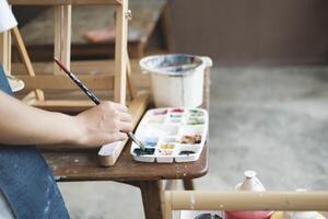 Crafting Inspiration Female Artist Sketching and Painting in Workshop photo