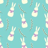 Seamless pattern of white Easter bunnies and willow branches on blue background. vector