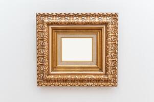 art display with touch of luxury using ornate gold frames. The gilded antique design adds elegance and retro charm to setting. The empty frames provide a blank canvas to showcase pictures or artwork. photo