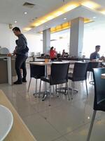 a man standing in a restaurant with a plate of food photo