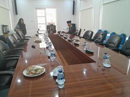 a conference table with chairs and a man standing in front of it photo