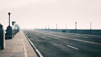 An empty illuminated asphalt road in a thick fog video