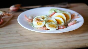 boiled eggs with boiled shrimp in a plate for breakfast video