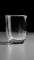 empty clear glass on table with black and white background photo