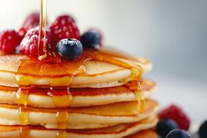 AI generated Fluffy Pancakes with Syrup and Berries - Delicious Breakfast Stack photo