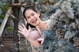 Portrait of teenage girl in a red dress relaxed and smiling in a snowy yard. photo