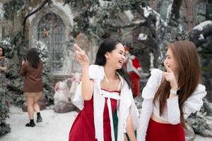 Portrait of teenage girl in a red dress relaxed and smiling in a snowy yard. photo