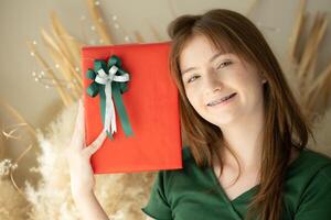 Portrait of Teenage girl with Christmas gift box. photo