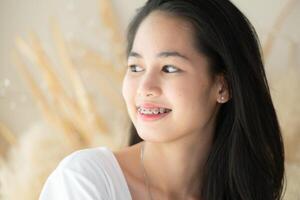 Portrait of a young asian woman with braces on her teeth photo