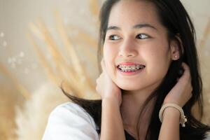 Portrait of a young asian woman with braces on her teeth photo