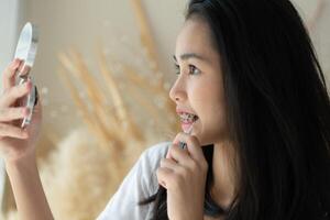 Portrait of a young asian woman with braces on her teeth photo