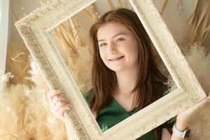 Portrait of Teenage girl with braces in picture frame photo