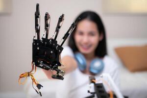 Portrait of Teenage girls students studying with hand robot model in the living room photo