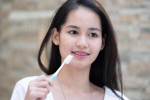 Portrait of a young asian woman with braces on her teeth photo