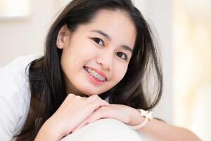 Portrait of a young asian woman with braces on her teeth photo