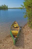 Canoe Ready on a Calm Lakeshore photo