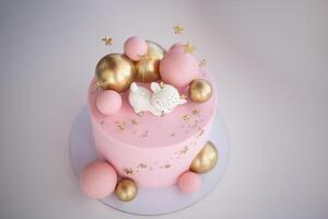 Birthday pink cake, decorated with meringue cookies on a grey background photo