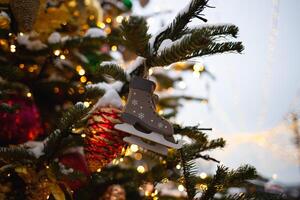 beautiful multi-colored toys on a Christmas tree against the background of lights and snow photo