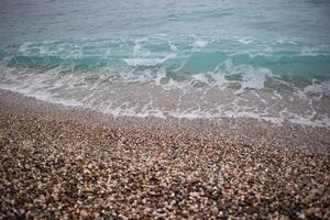 wave on the pebble shore. great background for your design photo