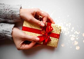 hands hold a gift on a white background photo