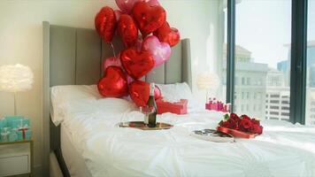 Beautiful red roses and heart balloons on white bed romantic surprise video