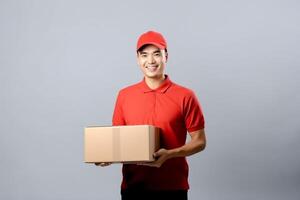 AI generated young Asian deliveryman is holding delivery box , logistics concept . photo