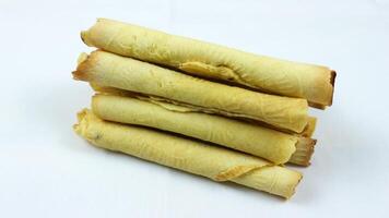 egg roll biscuit isolated on white background. Biscuits served during Ramadan and Eid al-Fitr photo