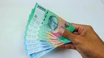 New Rupiah issued in 2023. Indonesian money bank notes isolated on white backgrounds. photo