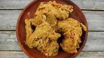 crispy kentucky fried chicken in a wooden table. Isolated on Grey background. photo