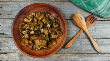 Orek tempe or Sauteed Tempe is a typical Indonesian cuisine with herbs, garlic, onion, chilli, long beans and soy sauce. it tastes delicious. isolated on grey background photo