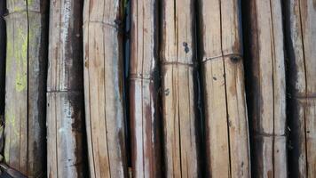 The texture under the background of dried bamboo is grey, vertically positioned. photo