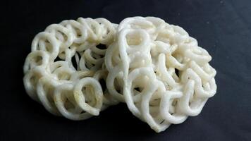 Krupuk or kerupuk Indonesian are deep fried crackers made from starch and other ingredients that serve as flavoring. photo