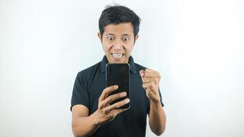 Disappointed, not expect, angry expression of asian man reading bad news at mobile phone isolated on white background. photo