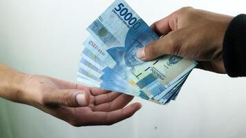 Hand hold money rupiah,transaction concept, financial concept photo