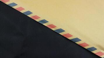 brown envelope on black background. Brown envelope front and back isolated on black background. Letter top view. Object with clipping path photo