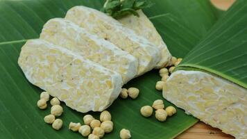 Tempe slices on a banana leaves. Tempeh or Tempe is an Indonesian specialty. photo