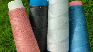 Colorful yarn spools used in the fabric and textile industry photo