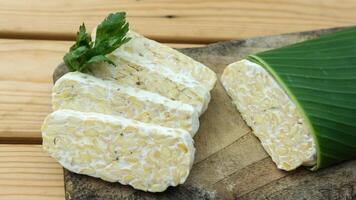 Tempe slices on a banana leaves. Tempeh or Tempe is an Indonesian specialty. photo